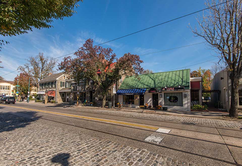 Cobblestone street with businesses in Chestnut Hill, Philadelphia, PA