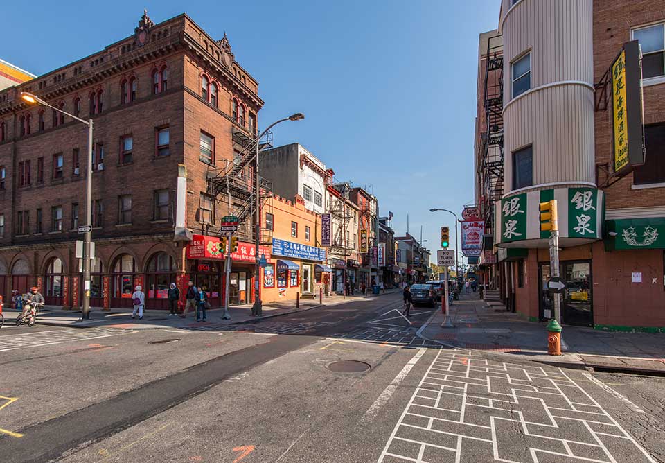Street corner with people walking in Chinatown, Philadelphia, PA